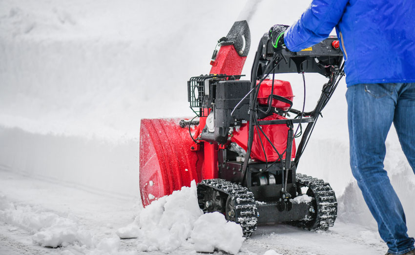 Clearing snow from driveway in Bala, North Wales